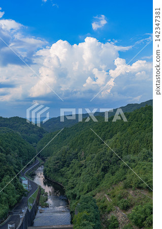 The flowing Nunome River and the summer sky above; Nunome Dam; 35mm; Copy space above; Vertical composition, river on the left; Suitable for B1 poster. The flowing Nunome River and the summer sky above; Nunome Dam; 35mm; Copy space above; Vertical composition, river on the left; Suitable for B1 poster. 142347381