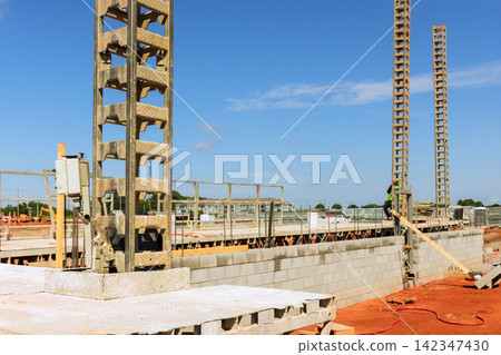 Workers are building walls with concrete blocks at construction site Workers are building walls with concrete blocks at construction site 142347430