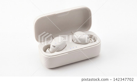 Pair of wireless earbuds inside an open charging case on a clean white background in ear with wireless charging bluetooth headphones technology portable electronic accessory container Pair of wireless earbuds inside an open charging case on a clean white background in ear with wireless charging bluetooth headphones technology portable electronic accessory container 142347702