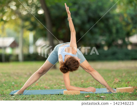 Adult woman doing yoga with blocks Adult woman doing yoga with blocks 142348223