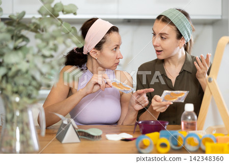 Adult and young women use eye patches Adult and young women use eye patches 142348360