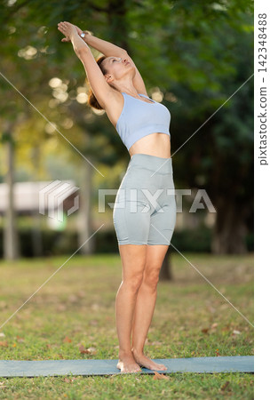 Adult woman doing yoga in park 142348488