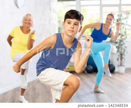Group of people in gym incendiary dance doing fitness Group of people in gym incendiary dance doing fitness 142348534