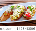 Enjoy a stylish and delicious bruschetta dish at a cafe on Seminyak Beach in Bali. 142348606