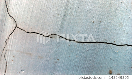 Horizontal cracks on the surface of a light blue painted concrete wall. Horizontal cracks on the surface of a light blue painted concrete wall. 142349295