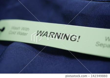 Cleaning instructions label on clothing item Cleaning instructions label on clothing item 142349860