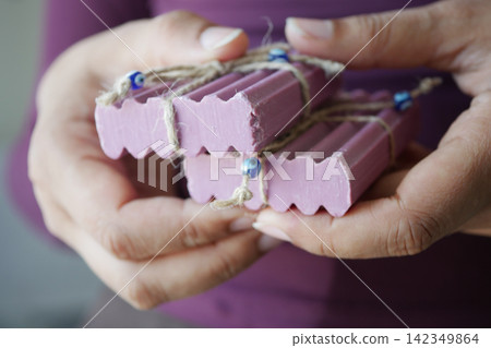 Hands with handmade soap and beads Hands with handmade soap and beads 142349864