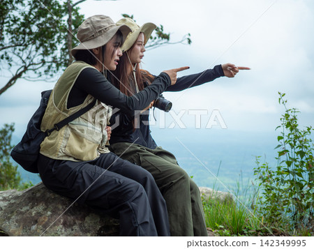 young couple enjoying the view of the mountain young couple enjoying the view of the mountain 142349995