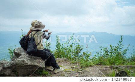 woman hiker enjoy the view on mountain peak 142349997