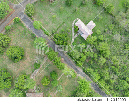 Aerial view of ecofriendly wellness retreat resort with secluded villa, garden paths and forest landscape. Sustainable hospitality, green tourism and peaceful nature accommodation. Eco tourism. Aerial view of ecofriendly wellness retreat resort with secluded villa, garden paths and forest landscape. Sustainable hospitality, green tourism and peaceful nature accommodation. Eco tourism. 142350603