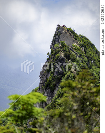 The majestic mountain scenery of Mt. Ishizuchi, perfect for use as a background in flyers and advertisements. The majestic mountain scenery of Mt. Ishizuchi, perfect for use as a background in flyers and advertisements. 142350683