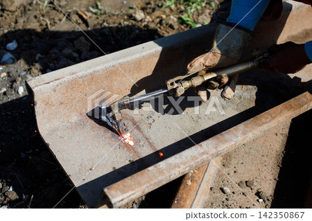 Industrial Gas Cutting of Massive Steel Beam with Sparks 142350867