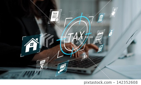 Business professional working on a laptop with digital tax icons overlayed on the screen, representing modern financial management and taxation processes. Gluon Business professional working on a laptop with digital tax icons overlayed on the screen, representing modern financial management and taxation processes. Gluon 142352608