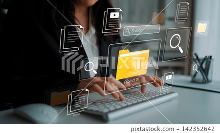 Young professional working on a computer in a modern office with digital interface elements showcasing file management and project organization concepts Gluon Young professional working on a computer in a modern office with digital interface elements showcasing file management and project organization concepts Gluon 142352642