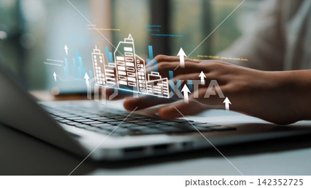 Business professional using laptop with urban growth graphics, data charts, and digital interface for financial analysis and strategic planning Gluon Business professional using laptop with urban growth graphics, data charts, and digital interface for financial analysis and strategic planning Gluon 142352725