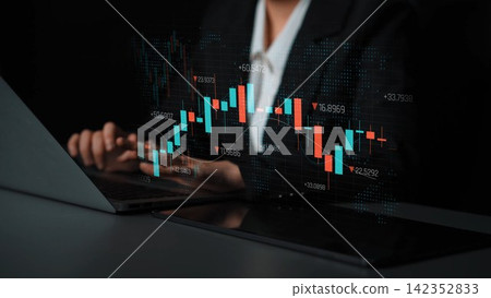 A business professional examines digital stock market data on a laptop, showcasing graphs and charts in a sleek dark environment, highlighting investment strategy and market analysis. Sigmoid A business professional examines digital stock market data on a laptop, showcasing graphs and charts in a sleek dark environment, highlighting investment strategy and market analysis. Sigmoid 142352833