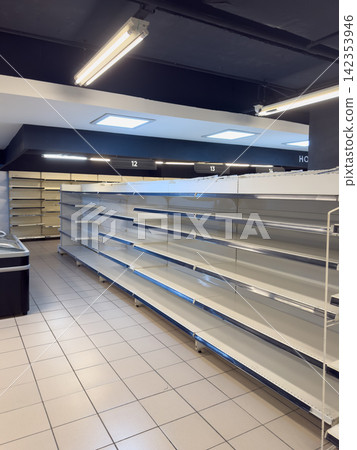 Long row of empty supermarket shelves showing food shortage and supply crisis Long row of empty supermarket shelves showing food shortage and supply crisis 142353946