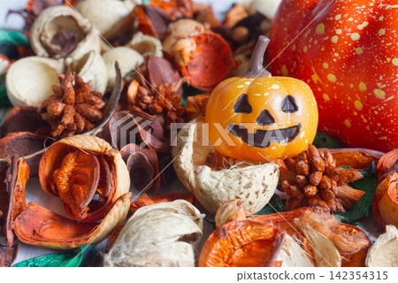 Smiling Halloween Jack-o'-lanterns and autumn potpourri: Warm and cozy seasonal decor Smiling Halloween Jack-o'-lanterns and autumn potpourri: Warm and cozy seasonal decor 142354315