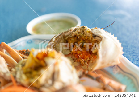 Steamed crab filled rich orange roe served spicy seafood dipping sauce highlighting fresh shellfish traditional Asian cuisine Steamed crab filled rich orange roe served spicy seafood dipping sauce highlighting fresh shellfish traditional Asian cuisine 142354341