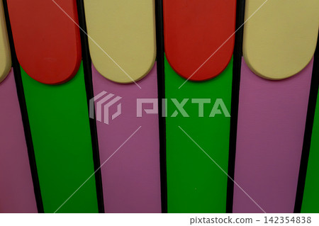 Colorful Wooden Fence Close Up Background with Red Yellow Green and Pink Panels Colorful Wooden Fence Close Up Background with Red Yellow Green and Pink Panels 142354838