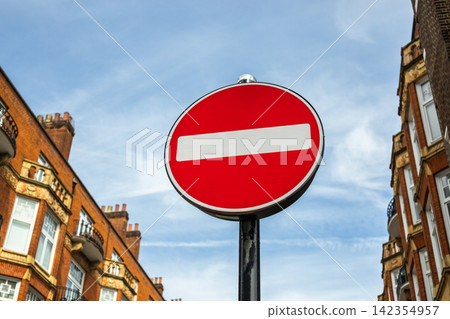 Red no entry road sign in an urban street 142354957