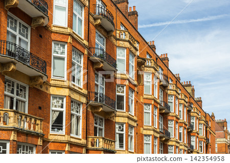 British red brick residential building facade with windows British red brick residential building facade with windows 142354958