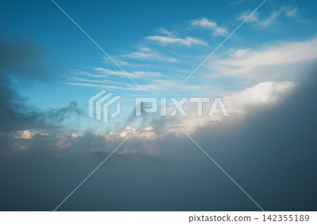 Blue sky and layers of clouds stretching above a sea of clouds. Blue sky and layers of clouds stretching above a sea of clouds. 142355189