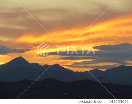 火焰般的落日雲彩,以及哈魯納山脈的全景;層層疊疊的山巒輪廓映襯著燃燒般的晚霞。 火焰般的落日雲彩,以及哈魯納山脈的全景;層層疊疊的山巒輪廓映襯著燃燒般的晚霞。 142355631