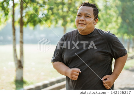 portrait of a fat man jogging in the morning in the park portrait of a fat man jogging in the morning in the park 142356237