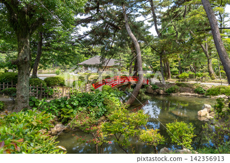 Red bridge in Shukkei-en Japanese garden in Hiroshima, Japan Red bridge in Shukkei-en Japanese garden in Hiroshima, Japan 142356913