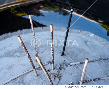 Burning incense sticks on Miyajima Island in Hiroshima, Japan Burning incense sticks on Miyajima Island in Hiroshima, Japan 142356915