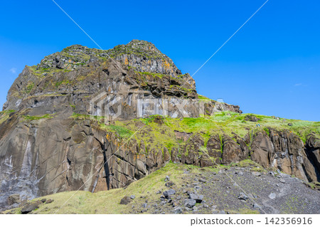 Rugged cliff landscape in Vestmannaeyjar, Iceland Rugged cliff landscape in Vestmannaeyjar, Iceland 142356916