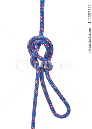 A double figure-eight loop knot is tied in a purple and blue rope. A double figure-eight loop knot is tied in a purple and blue rope. 142357321