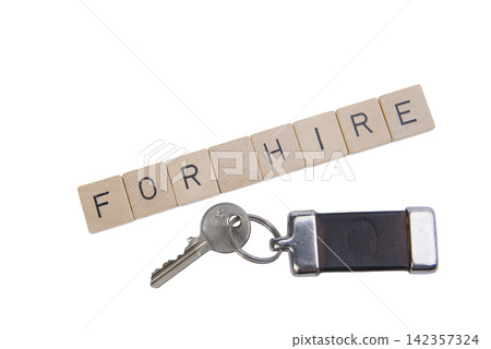Wooden letter tiles spell "FOR HIRE" above a key and keychain. Wooden letter tiles spell "FOR HIRE" above a key and keychain. 142357324