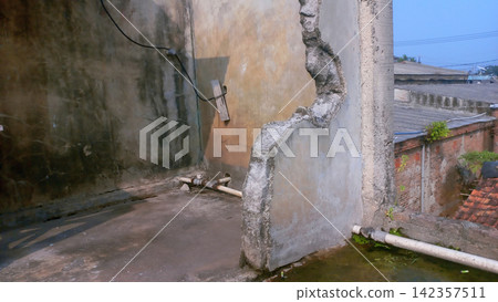 A partially demolished concrete wall in an abandoned building. A partially demolished concrete wall in an abandoned building. 142357511