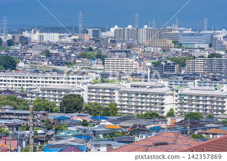 A vast residential area and power transmission towers viewed from a hilltop in Hino City, Tokyo. A vast residential area and power transmission towers viewed from a hilltop in Hino City, Tokyo. 142357869