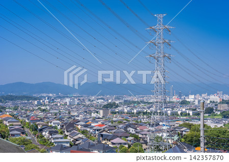 A vast residential area and power transmission towers viewed from a hilltop in Hino City, Tokyo. 142357870
