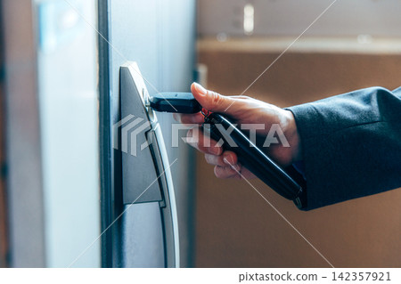 A man unlocks the door at the front door. A man unlocks the door at the front door. 142357921