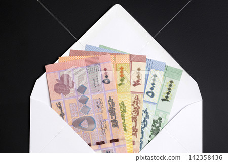 Lebanese money - pound in a white envelope Lebanese money - pound in a white envelope 142358436