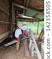 backpack sprayer under the shed in rural farm 142358505