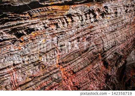 Cooled lava showing brittle grey crust above red fractures, Raufarholshellir, Iceland Cooled lava showing brittle grey crust above red fractures, Raufarholshellir, Iceland 142358719