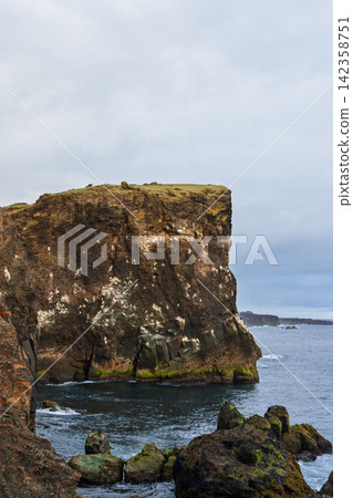 Valahnukamol cliffs towering above surf along a steep volcanic coast, Reykjanes, Iceland Valahnukamol cliffs towering above surf along a steep volcanic coast, Reykjanes, Iceland 142358751