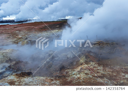 Steam rising across Gunnuhver near distant power-plant plumes, Reykjanes Peninsula, Iceland Steam rising across Gunnuhver near distant power-plant plumes, Reykjanes Peninsula, Iceland 142358764