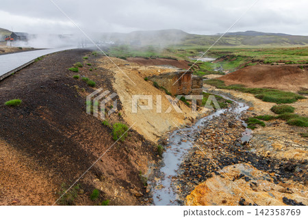 Shallow mineral stream beside a wooden boardwalk at Seltun, Reykjanes, Iceland Shallow mineral stream beside a wooden boardwalk at Seltun, Reykjanes, Iceland 142358769