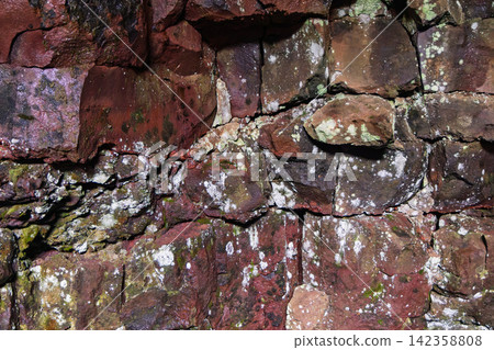Cooled lava showing a fractured red basalt wall in close detail, Raufarholshellir, Iceland Cooled lava showing a fractured red basalt wall in close detail, Raufarholshellir, Iceland 142358808