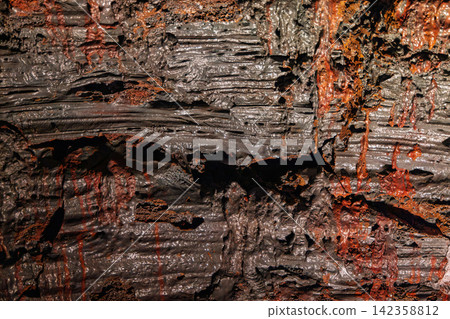 Cooled lava displaying grey and red ropy texture in closeup, Raufarholshellir, Iceland Cooled lava displaying grey and red ropy texture in closeup, Raufarholshellir, Iceland 142358812