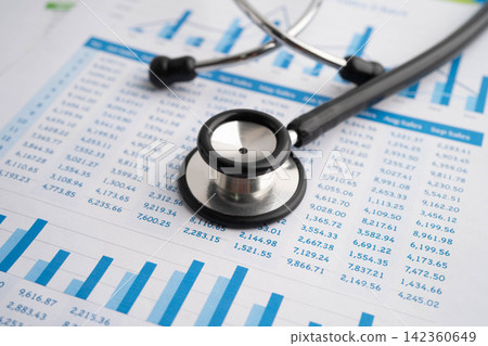 Stethoscope on chart or graph paper, Financial, account, statistics and business data medical health. Stethoscope on chart or graph paper, Financial, account, statistics and business data medical health. 142360649