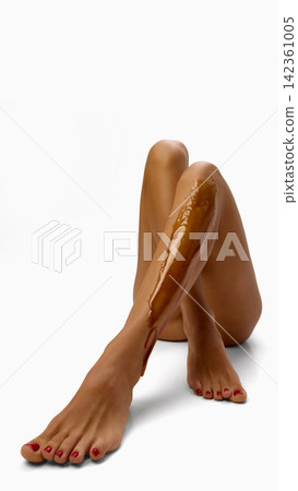 Closeup of wax layer on smooth female shin Closeup of wax layer on smooth female shin 142361005