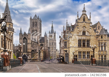 Historic center of Ghent, Belgium, view from bridge. Panorama of medieval stone towers and gothic churches under cloudy sky Historic center of Ghent, Belgium, view from bridge. Panorama of medieval stone towers and gothic churches under cloudy sky 142361596