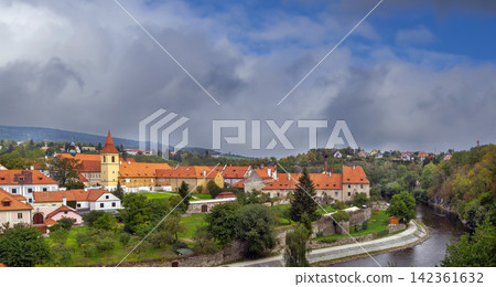 Minorite Monastery view across Vltava river in Cesky Krumlov, Czechia. Medieval religious architecture under cloudy sky Minorite Monastery view across Vltava river in Cesky Krumlov, Czechia. Medieval religious architecture under cloudy sky 142361632